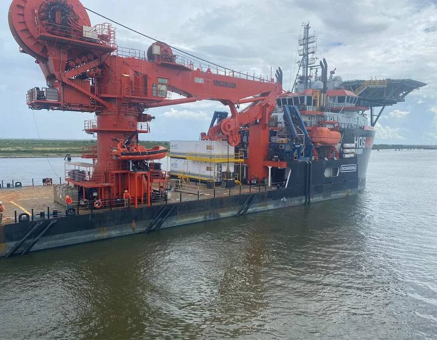 Offshore support vessel transporting modular equipment near an offshore platform, highlighting transportation and installation considerations for offshore modules.