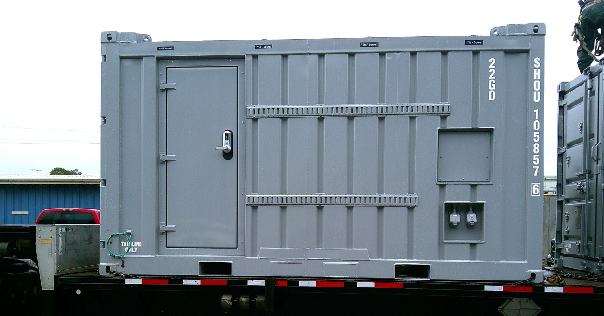 Modified DNV 2.7-1 offshore container with personnel door, utility connections and exterior equipment supports.