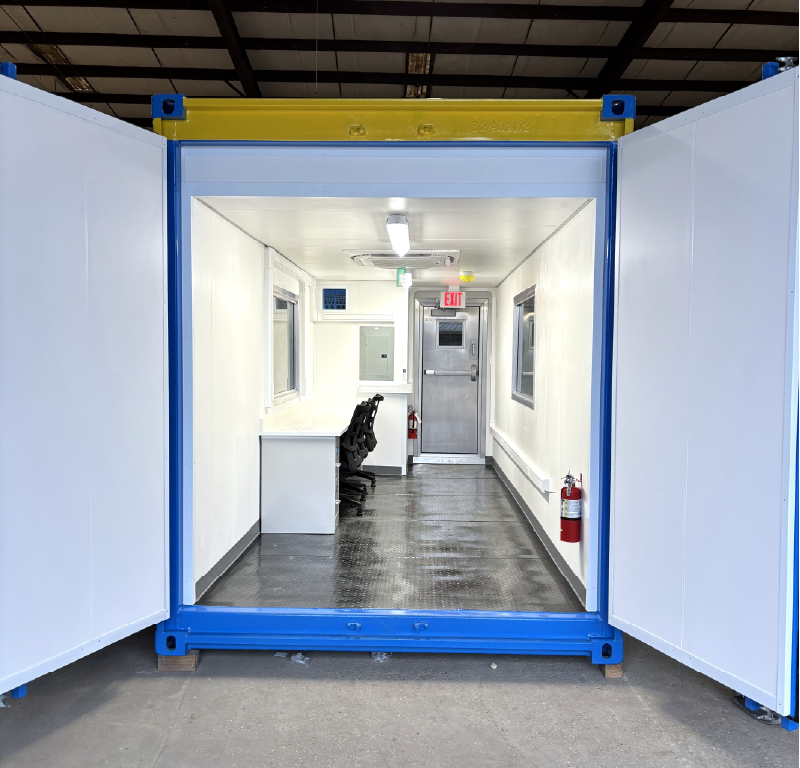 Modified offshore container configured as an office with workstations, windows, lighting and personnel door.