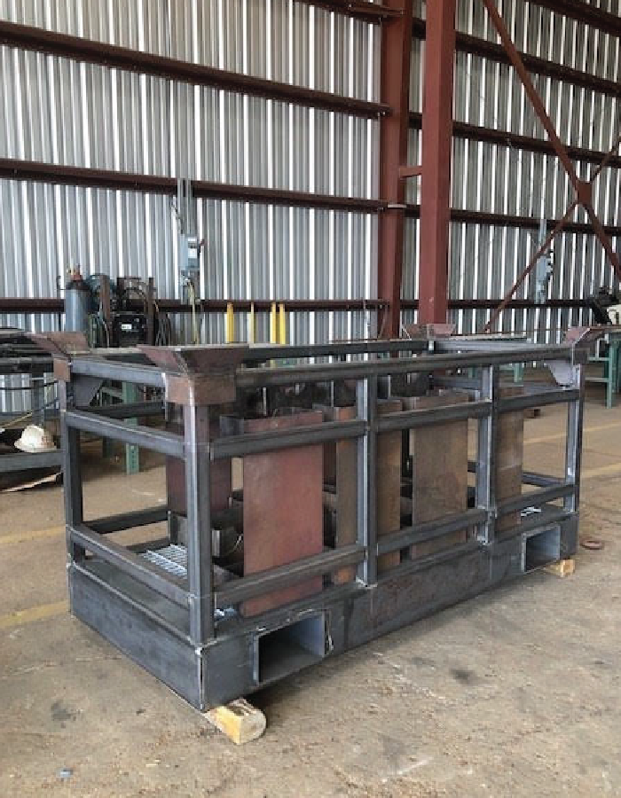 Welded steel equipment skid under fabrication in an offshore module manufacturing facility.