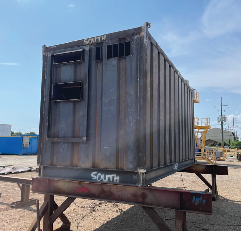 Offshore module shell under construction with steel walls and structural framing in place.