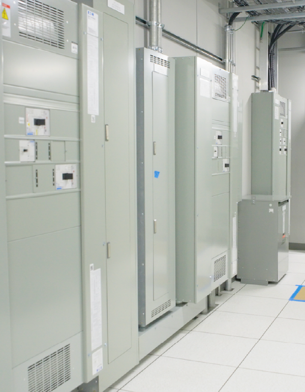 Electrical control panels and equipment cabinets installed inside a modular technical building.